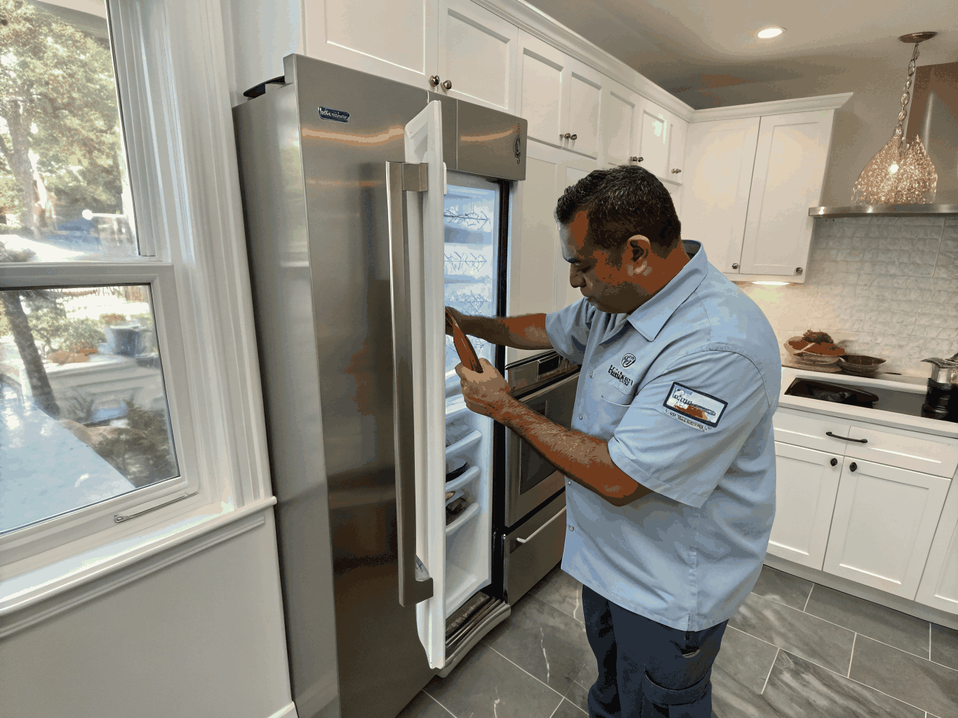Technician inspecting and replacing a refrigerator rubber door gasket seal in Lithonia GA