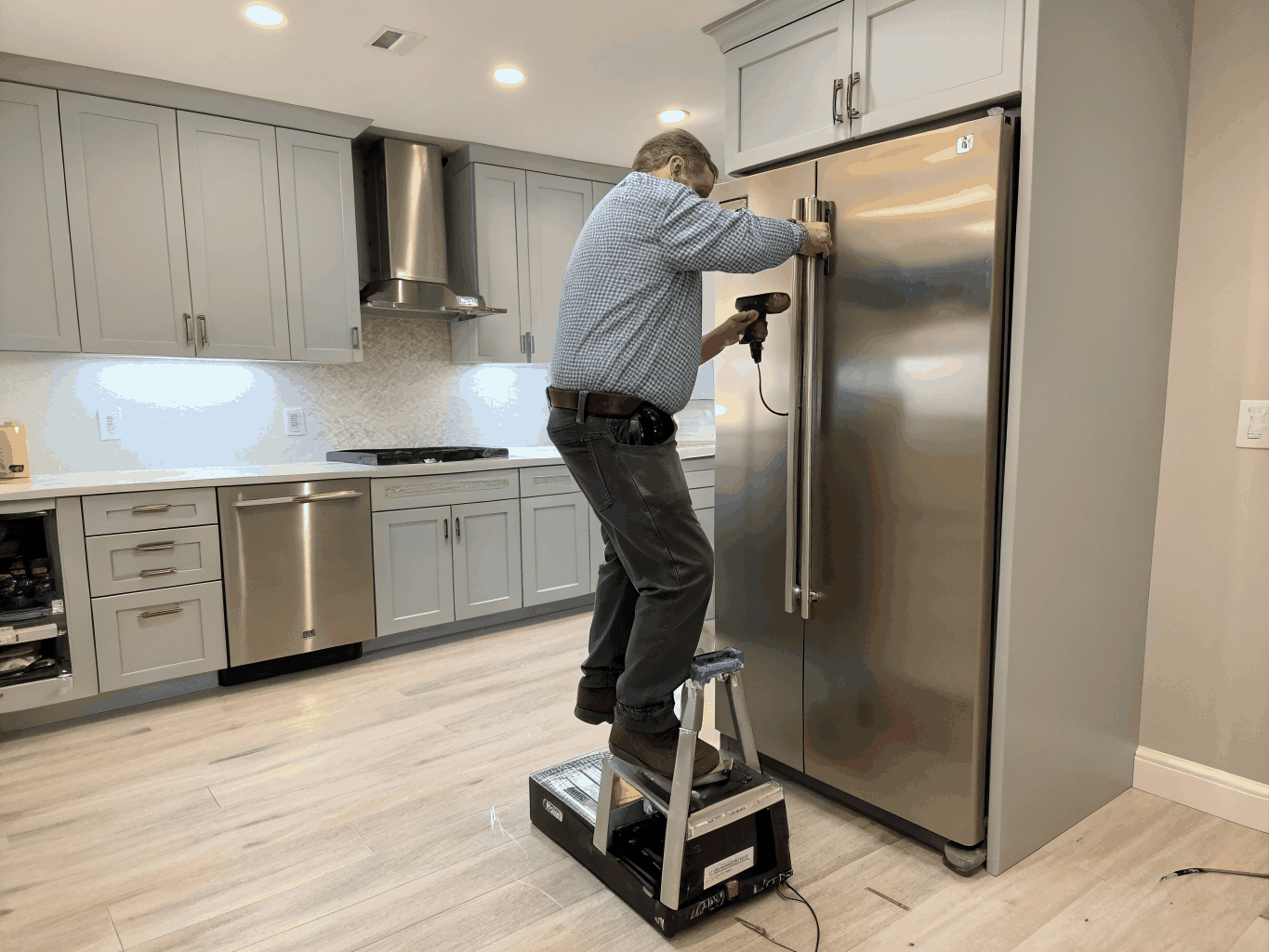 Whirlpool certified technician repairing modern kitchen appliance in Lithonia GA